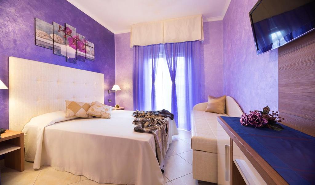 Postel nebo postele na pokoji v ubytování Hotel Petronio
