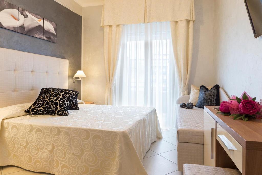 Postel nebo postele na pokoji v ubytování Hotel Petronio
