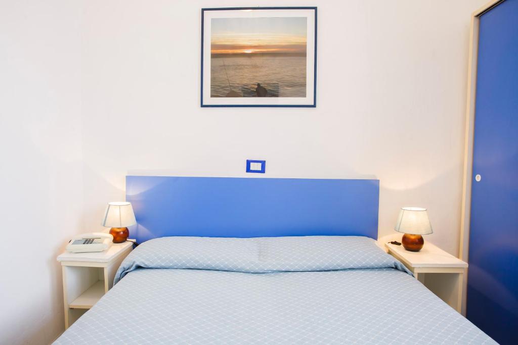 Postel nebo postele na pokoji v ubytování Hotel Rex