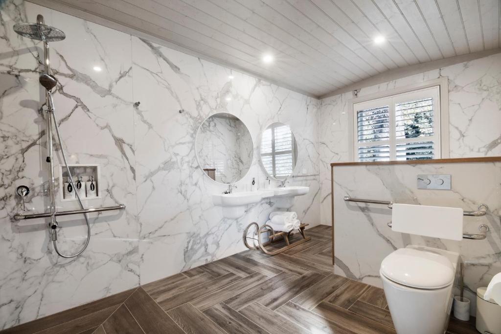 a white bathroom with a sink and a toilet at The Rivulet in Hobart