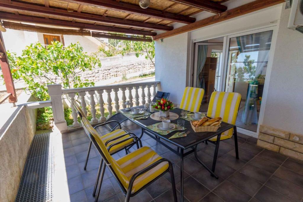 a patio with a table and chairs on a balcony at One-Bedroom Apartment in Crikvenica LIII in Dramalj