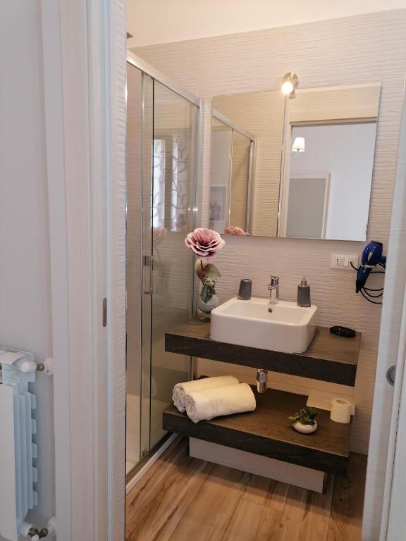 a bathroom with a sink and a mirror at Hotel Antica Cascina Del Golfo in Scopello