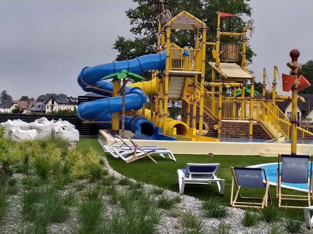 a water park with a playground with a slide at Bel Mare Patio and Garden C108 in Międzyzdroje