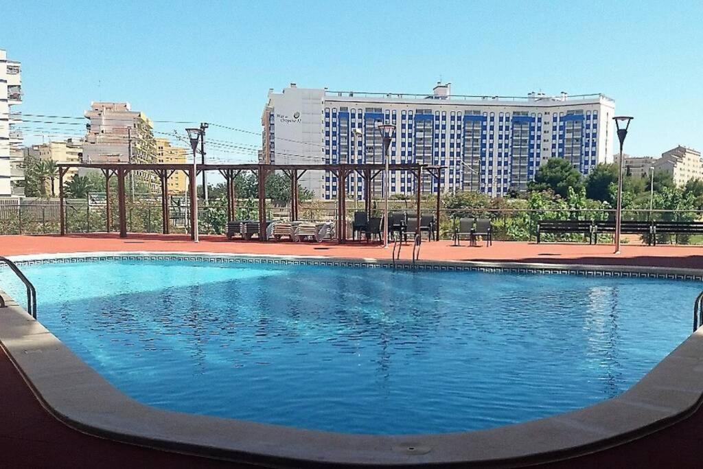 a large swimming pool in front of a large building at EDIFICIO ALGAIDA - NEW VISTA MONTAÑA - PLAYA DE LA CONCHA in Oropesa del Mar