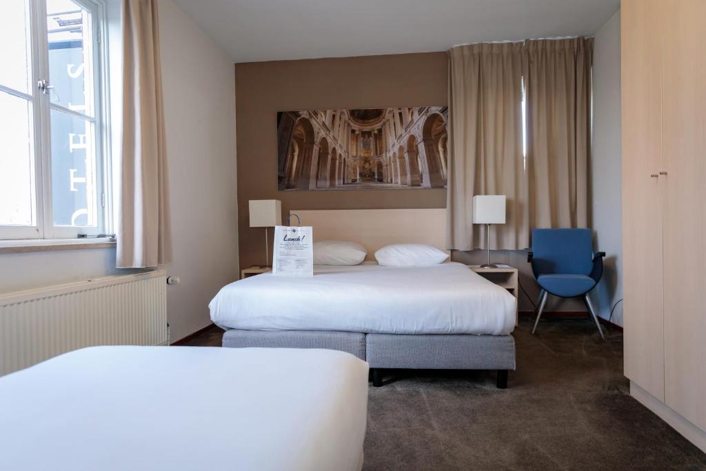 Postel nebo postele na pokoji v ubytování Fletcher Kloosterhotel Willibrordhaeghe