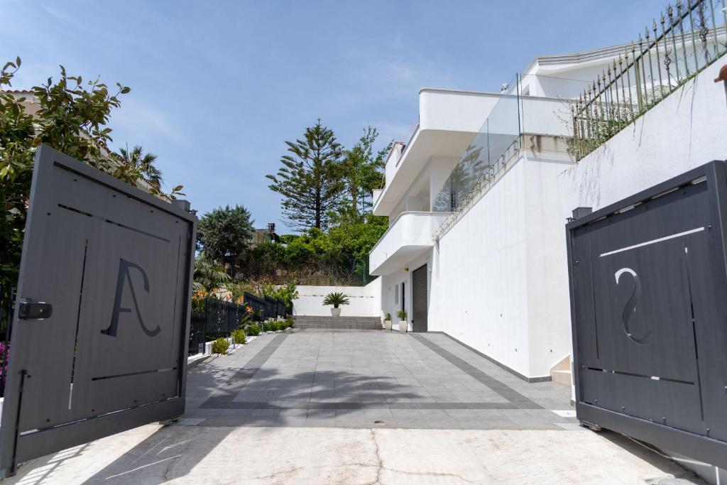 two doors with the letters a and q on them in front of a building at Prestige house 4 in Scalea