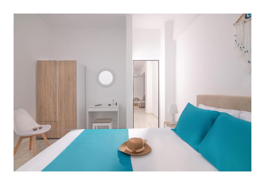 a bedroom with a bed with a hat on it at Kastri Mare Sea View Residences by Estia in Keratokampos