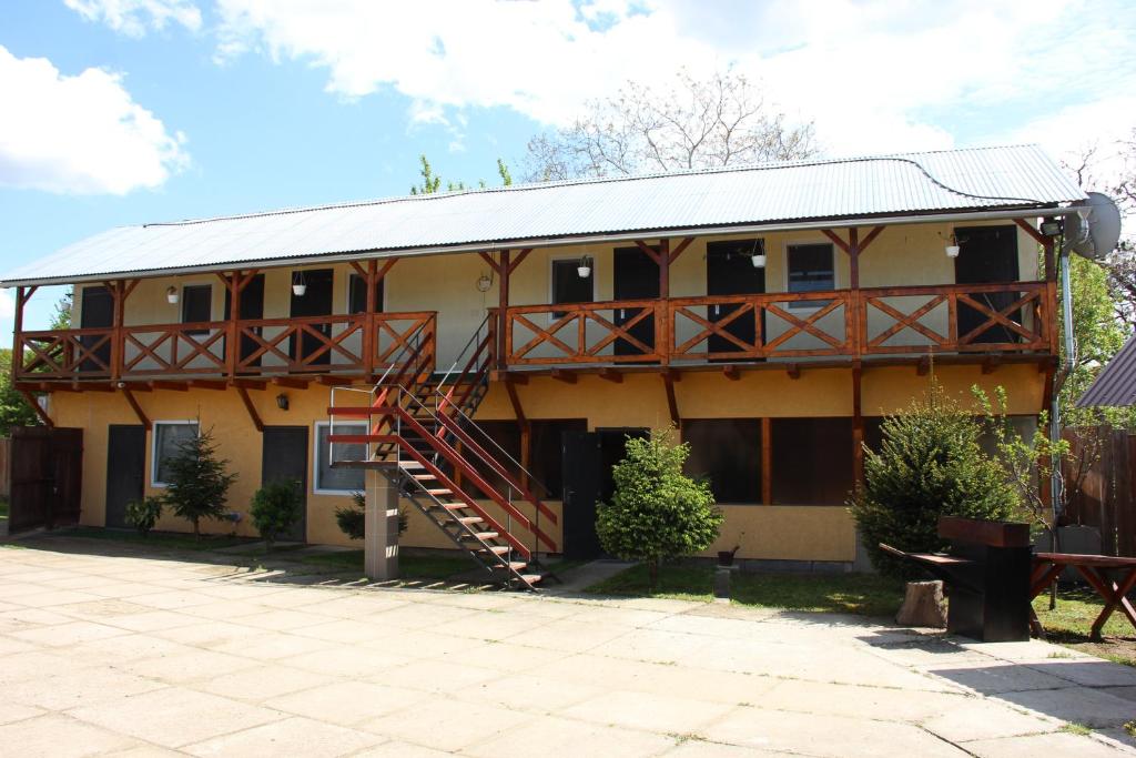 a house with a balcony and a staircase on it at Мотель Ріта in Berehove