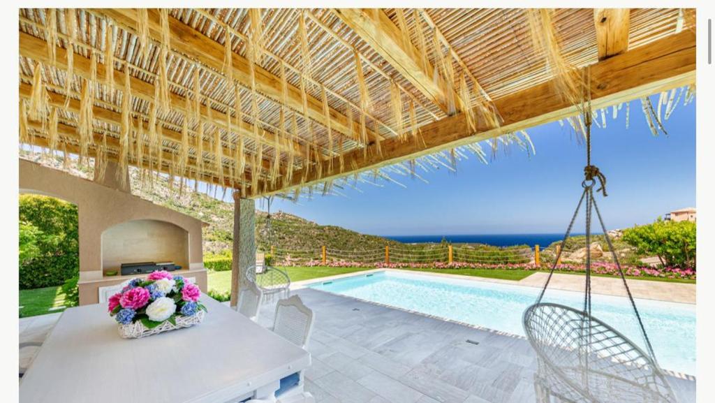 a villa with a swing and a swimming pool at Sardinia Family Villas - Villa MariaPia with private pool and seaview in Porto Cervo