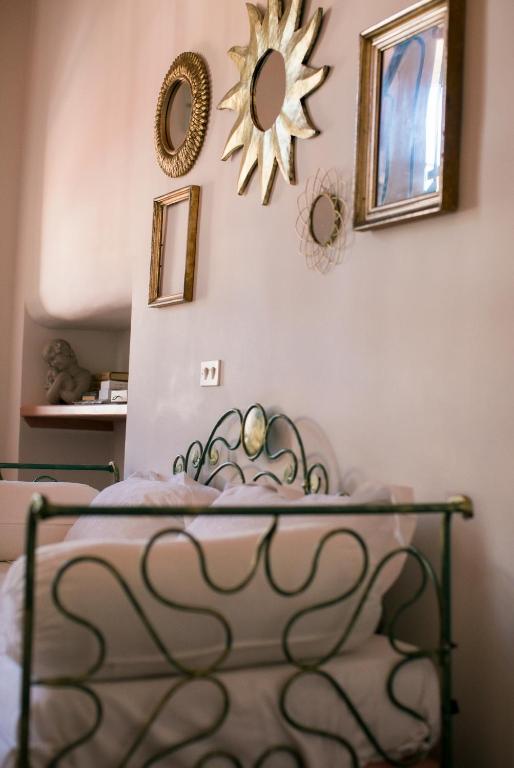 a bedroom with a bed with a mirror on the wall at B&B Agapantus in una Villa dell'800 in Dolceacqua