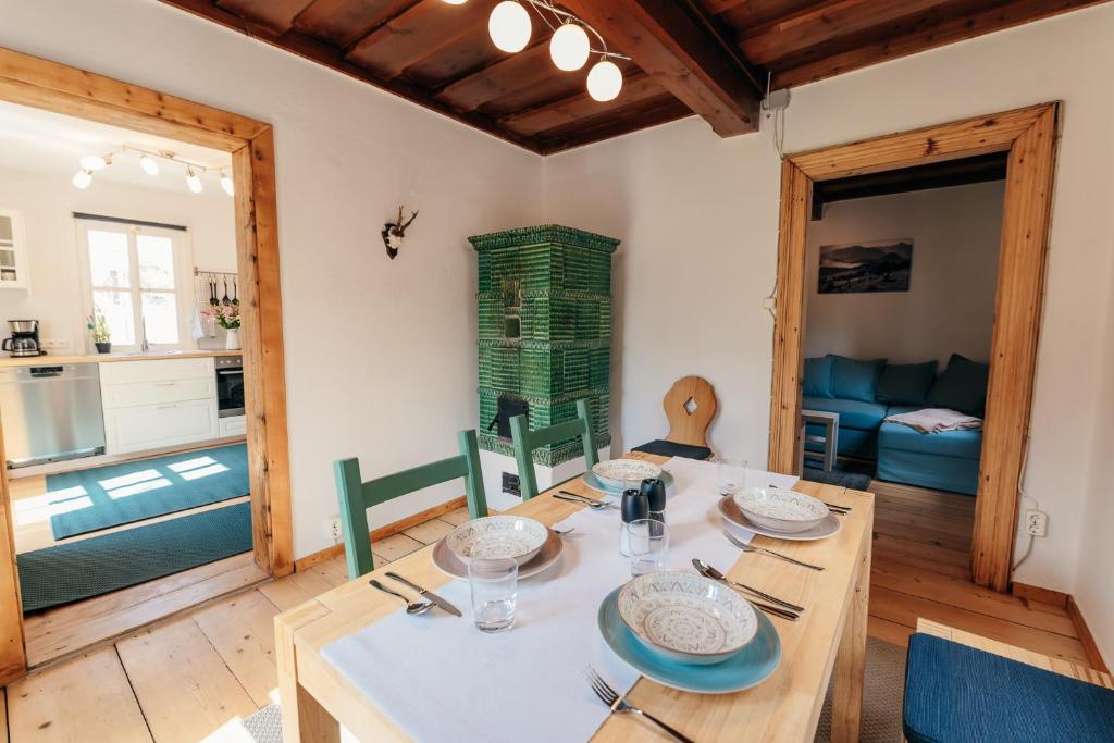 a kitchen and dining room with a table and chairs at s´Manz in Grundlsee