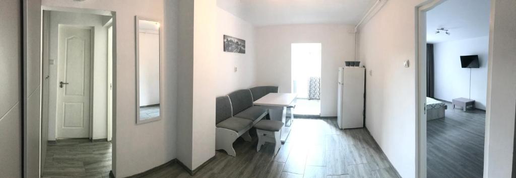 a room with a table and chairs and a refrigerator at Apartament Langa Plaja Diana in Mangalia