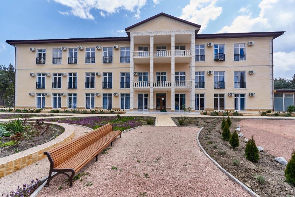 a building with a bench in front of it at Кристалл in Alushta