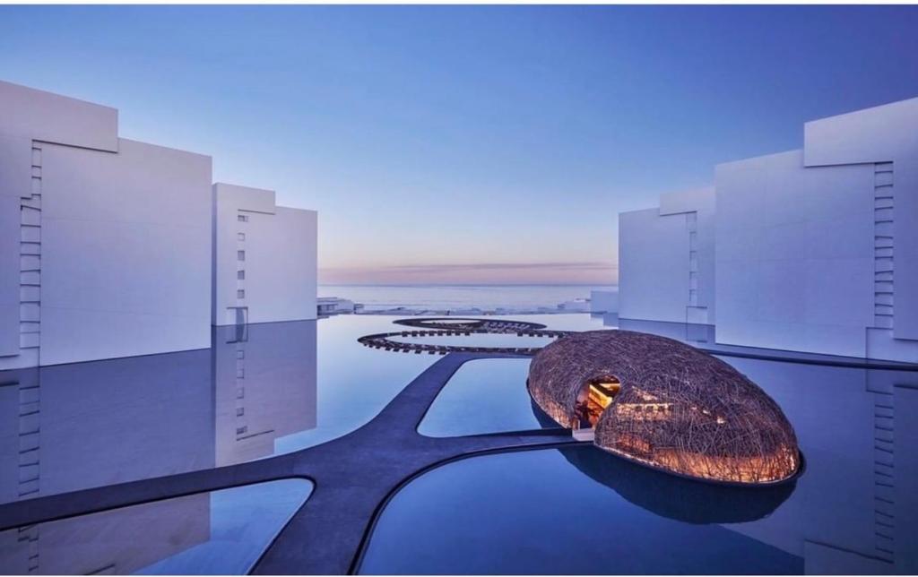 a rendering of a building with a rock in the water at Viceroy Los Cabos Oceanview Apartment in San José del Cabo