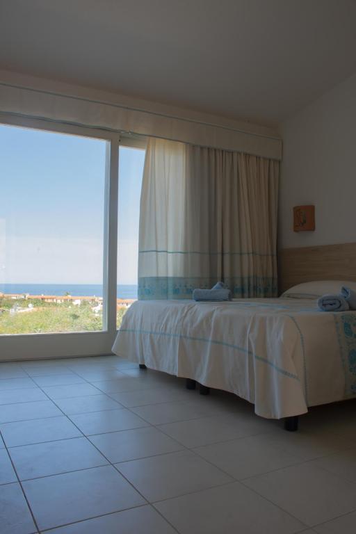 Postel nebo postele na pokoji v ubytování GH Santina Resort & SPA