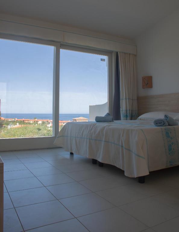 Postel nebo postele na pokoji v ubytování GH Santina Resort & SPA