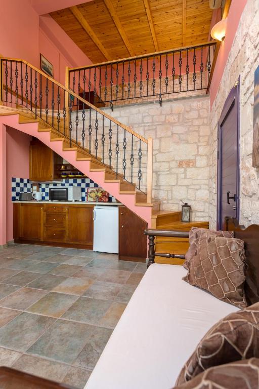 a living room with a staircase and a kitchen at ELIA VILLA 1 in Alikanas