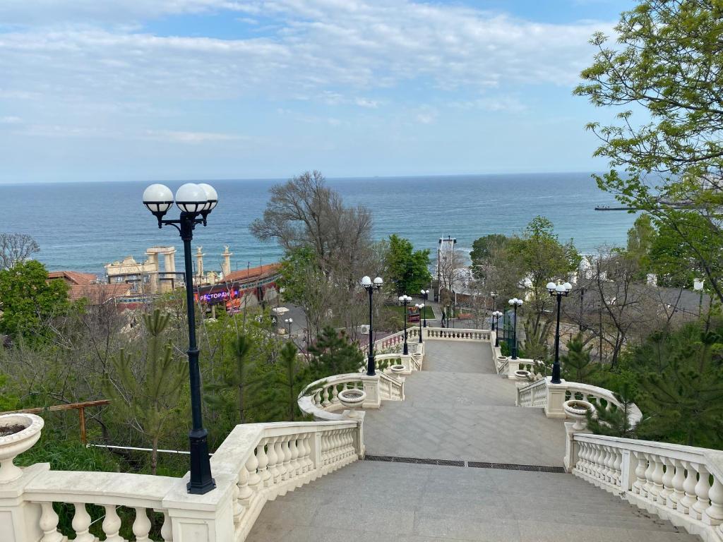 a white bridge with a walkway leading to the ocean at Arcadia sky in Odesa