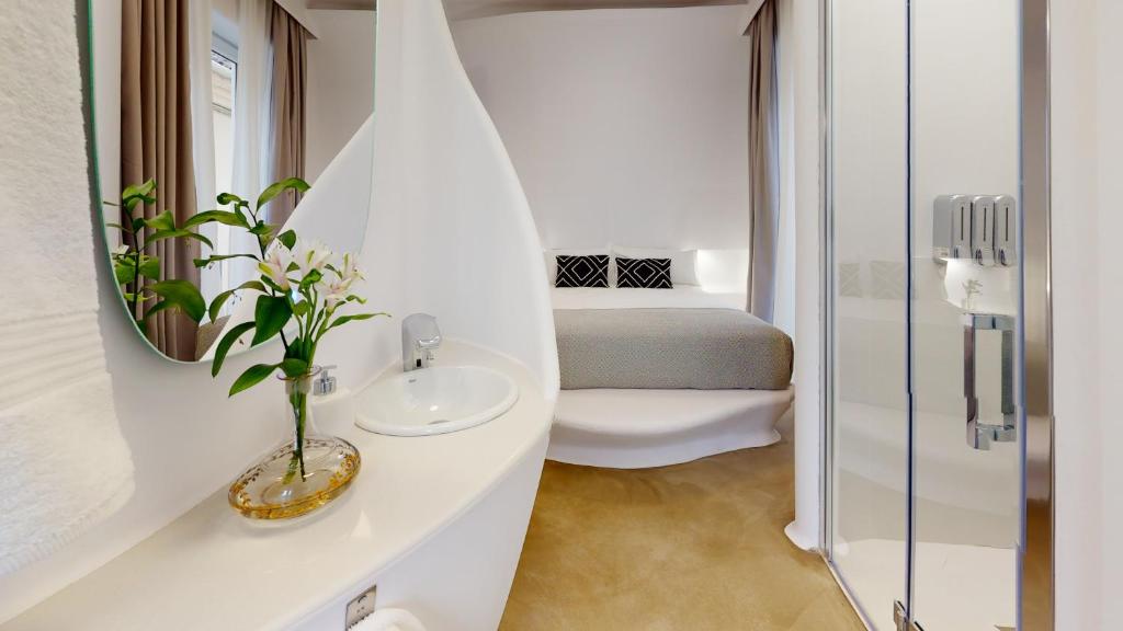 
a bathroom with a white tub and a white toilet at Hotel Suite Generis - in Córdoba
