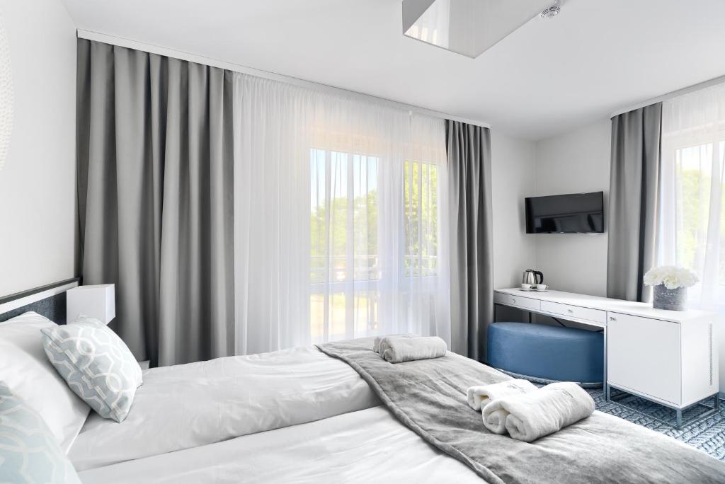Postel nebo postele na pokoji v ubytování Szymański Holiday Rooms