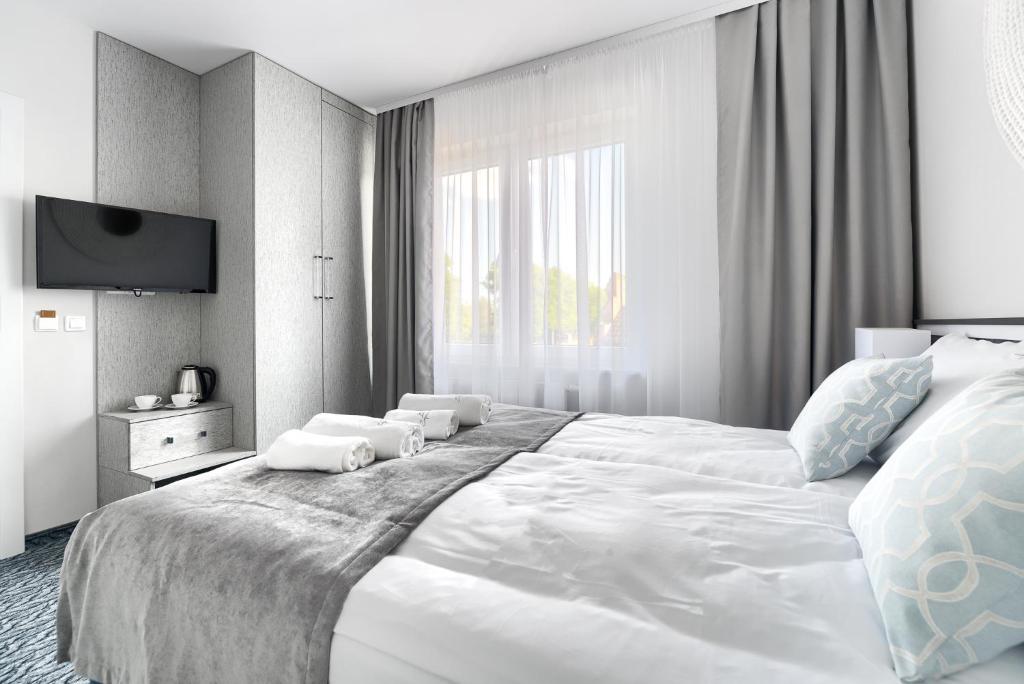 Postel nebo postele na pokoji v ubytování Szymański Holiday Rooms