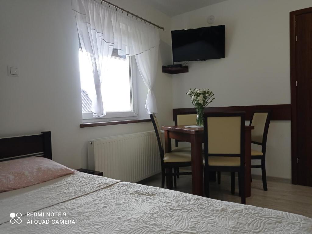 Posteľ alebo postele v izbe v ubytovaní Wypoczynek Pod Lasem