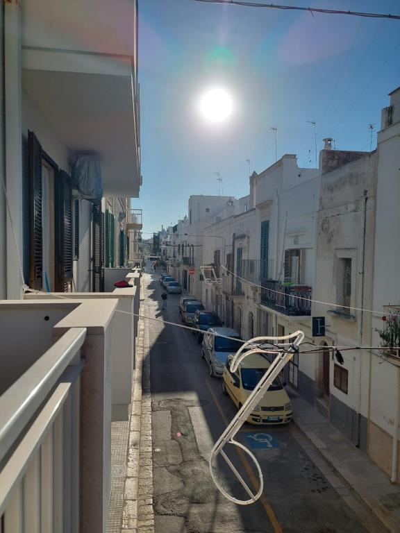 a street with cars parked on the side of a building at Only Bed in Polignano a Mare