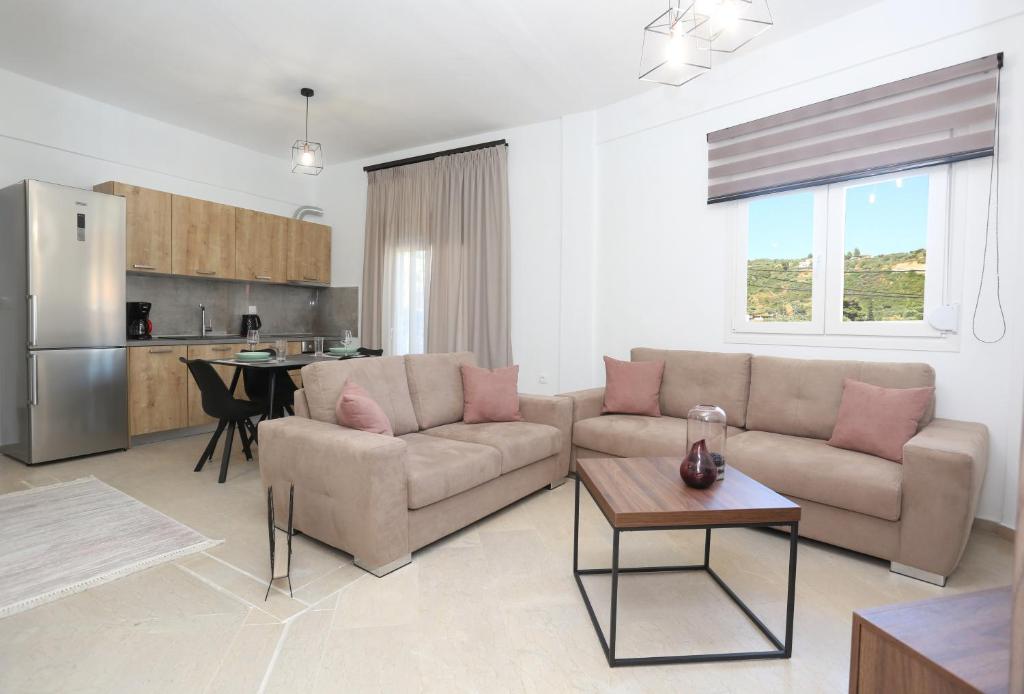 a living room with a couch and a table at Mare Monte Luxury Apartments 2 in Nea Skioni