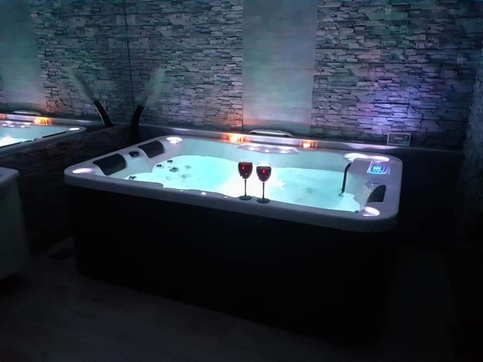 two glasses of wine sitting in a hot tub at Glamour Wellness Apartments in Zagreb