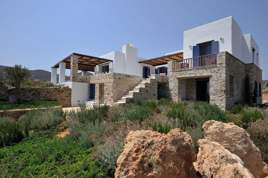 a house with a rock in front of it at VILLA SOROS in Antiparos