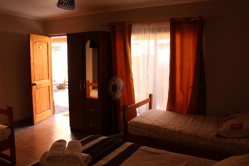 Postel nebo postele na pokoji v ubytování Vicuña Lodge