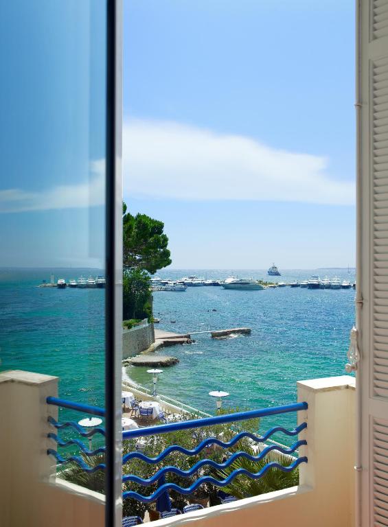 a view of a body of water from a window at Hôtel Belles Rives in Juan-les-Pins