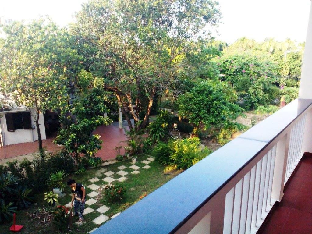 an overhead view of a man standing on a checkered at Nguyen Duy homestay in Hoi An