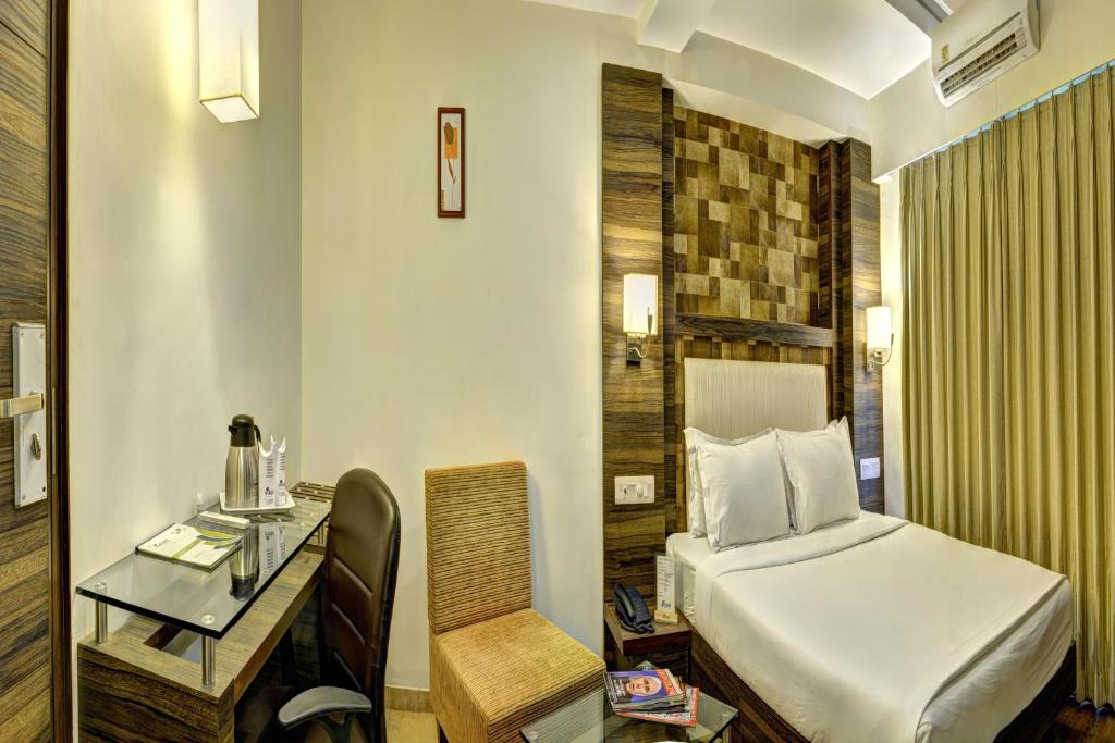 Postel nebo postele na pokoji v ubytování Hotel Aaram Orchard