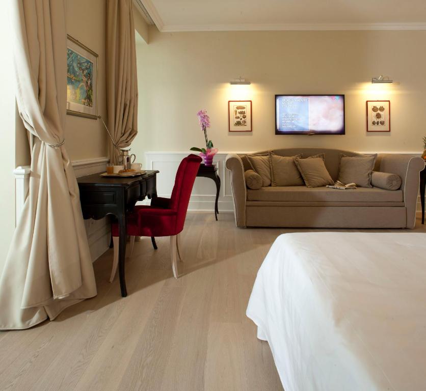 a living room with a couch and a table at Hotel Riviera & Maximilian's in Trieste