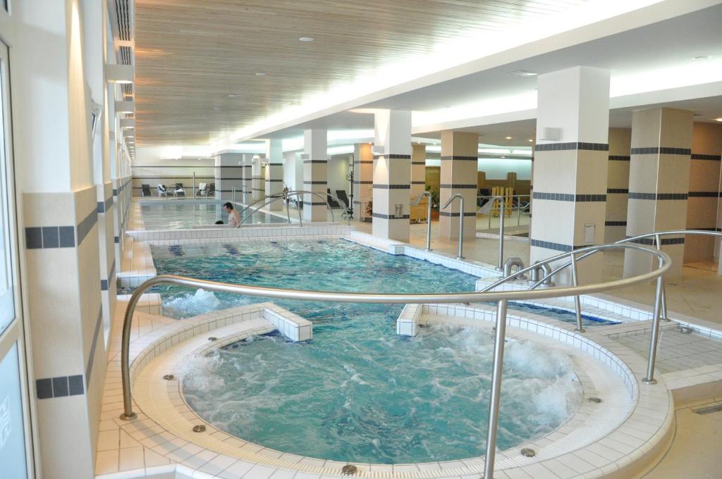 a large indoor swimming pool in a building at Ensana Bradet in Sovata