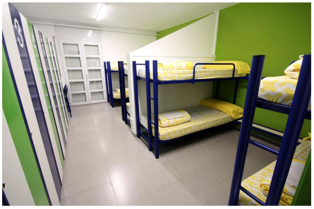 a room with three bunk beds and a hallway at La Seu d'Urgell Xanascat in La Seu d'Urgell