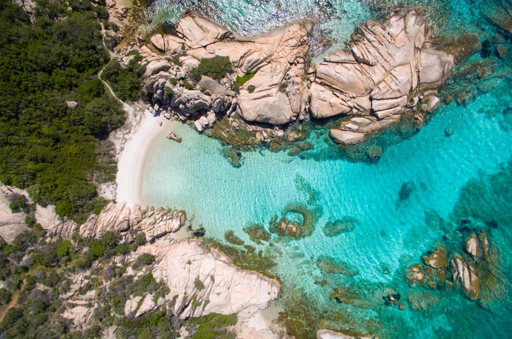 an aerial view of a beach with rocks and water at Casa Podda in San Teodoro