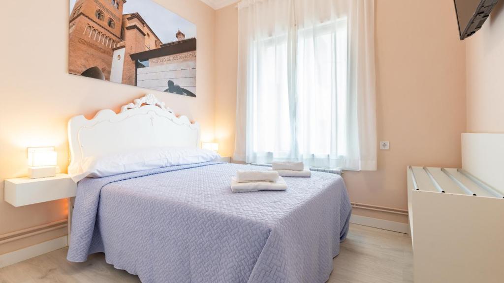 Postel nebo postele na pokoji v ubytování Balcon del Torico