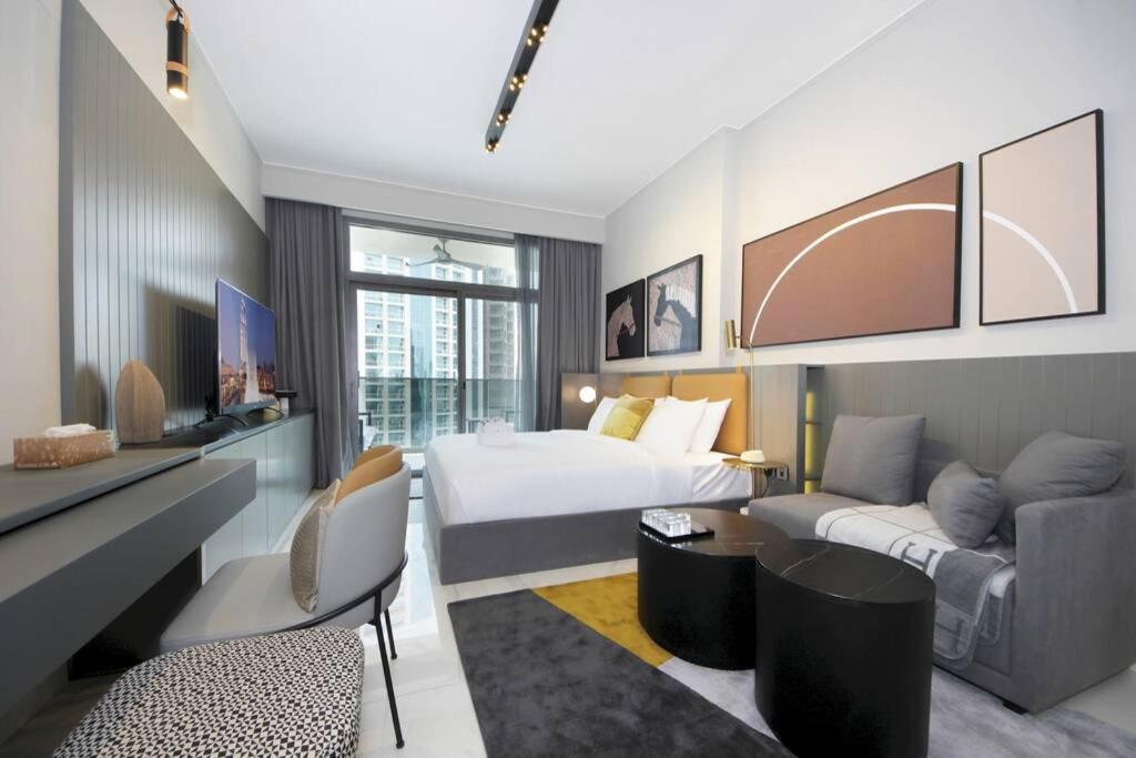 a hotel room with a bed and a couch at New Arabian MAG 318 Business Bay in Dubai