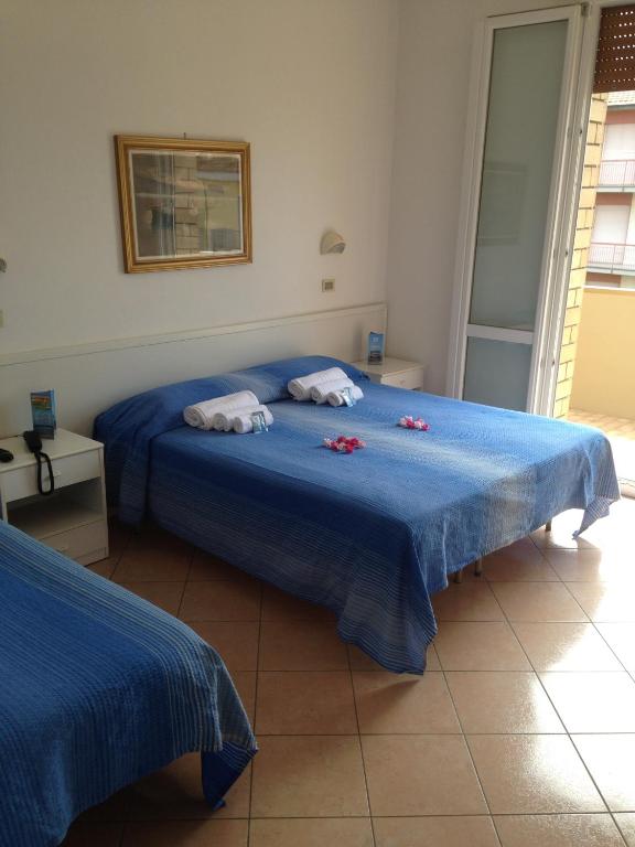 Postel nebo postele na pokoji v ubytování Hotel Primula