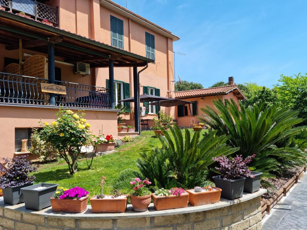a row of potted plants in front of a building at Il Casale nel Parco Guesthouse in Rome