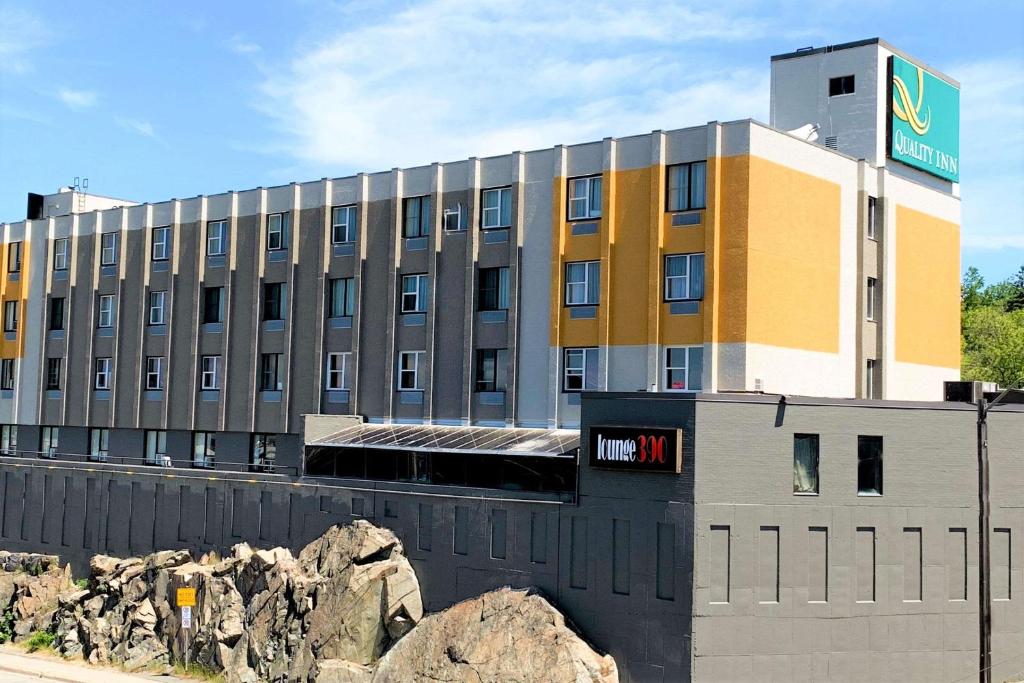 a building with a sign on the side of it at Quality Inn & Conference Centre Downtown Sudbury in Sudbury