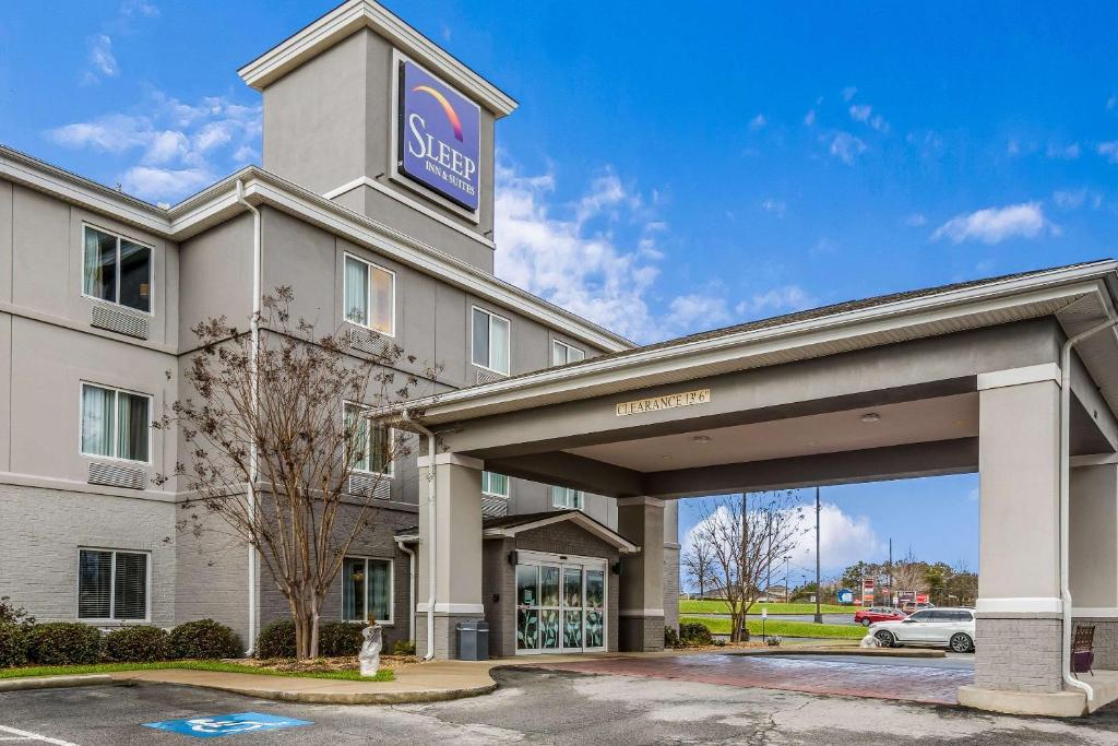 a hotel with a sign on top of a building at Sleep Inn & Suites Hiram in Hiram