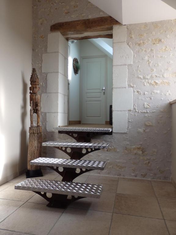 a hallway with stairs and a door in a building at Gîte Les Nymphéas in Épeigné-les-Bois