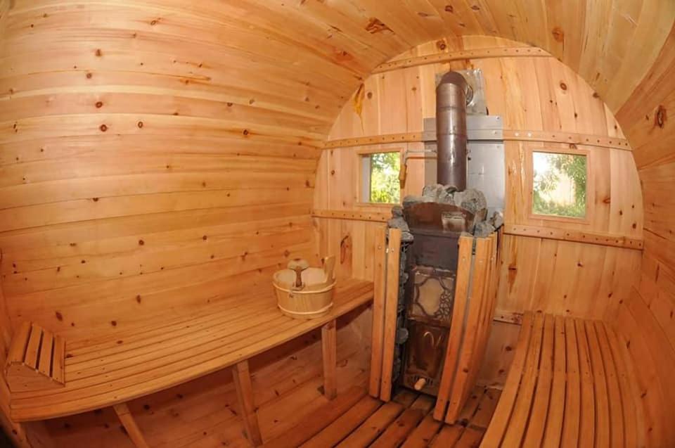an inside of a wooden cabin with a stove at Domki letniskowe "Słoneczna Polana" Jarosławiec in Jarosławiec