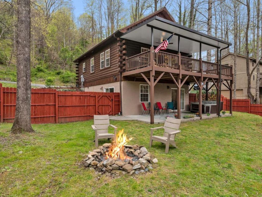 a fire pit in a yard in front of a house at Soco Serene Cabin in the Heart of Maggie Valley in Maggie Valley