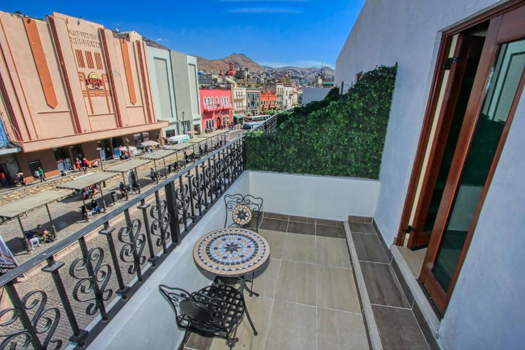 a balcony with a table and chairs on a balcony at Hotel Santa Rita in Guanajuato