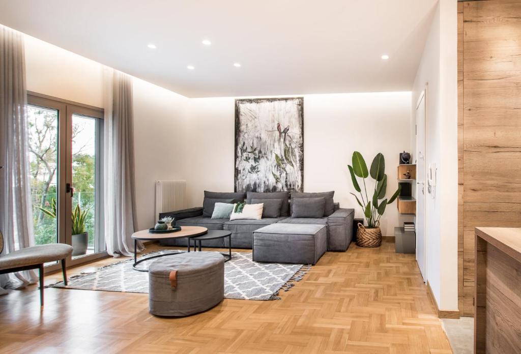 a living room with a couch and a table at Tree Olive Athens in Athens