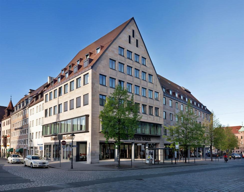 a large building on a street in a city at Sorat Hotel Saxx Nürnberg in Nürnberg